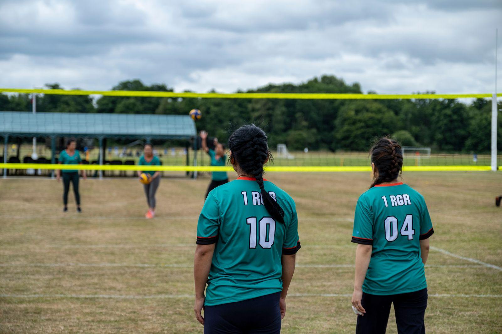 Volleyball players on a grass field